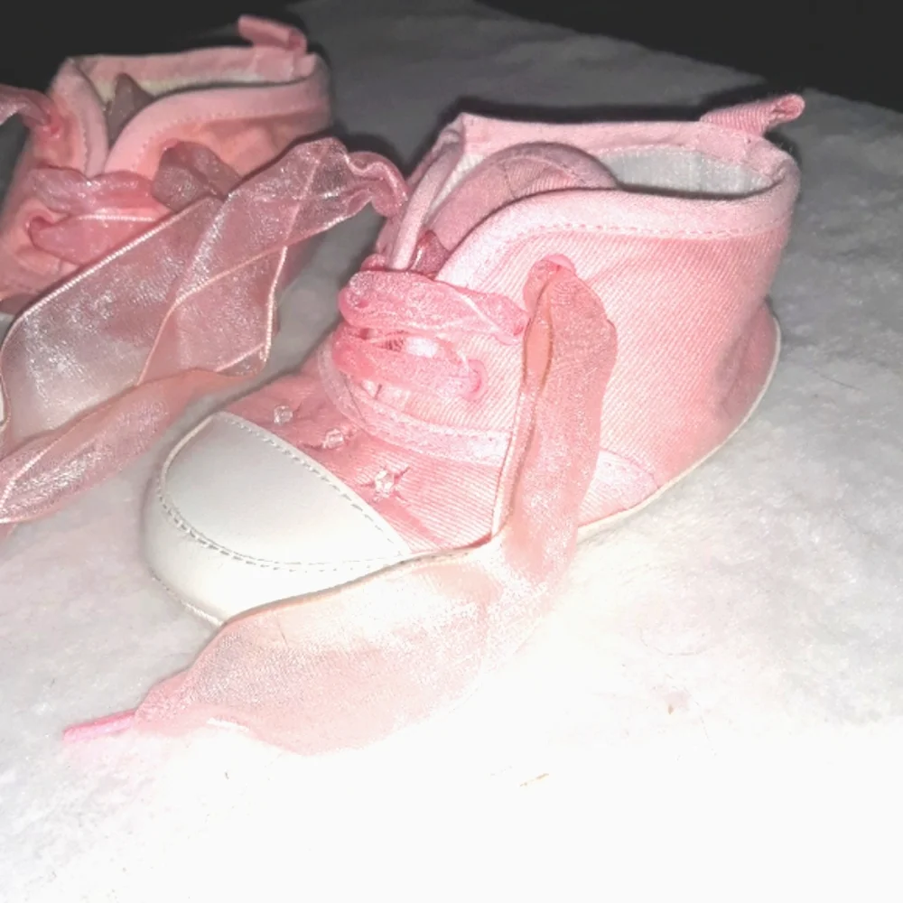 Pink baby sneakers with moon and star beaded accents and fun laces
